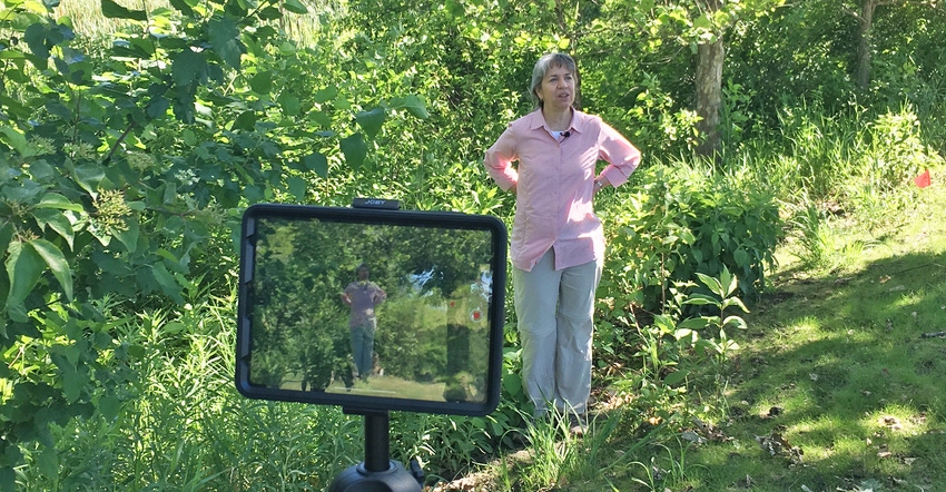 A woman member of the Conservation Learning Group being videotaped.