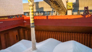 Loading fertilizer into the hold of a ship for transport