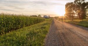 road toward farm at sunset