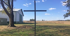 homemade wooden cross standing in rural yard