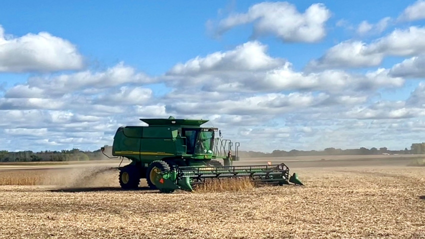John Deere combine harvesting soybean field