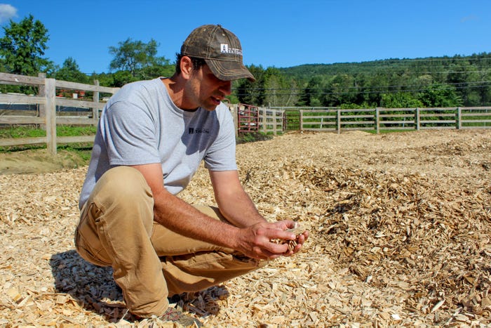 Joshua Faulkner checks out the new bed of soft woodchips on Kenyon’s farm