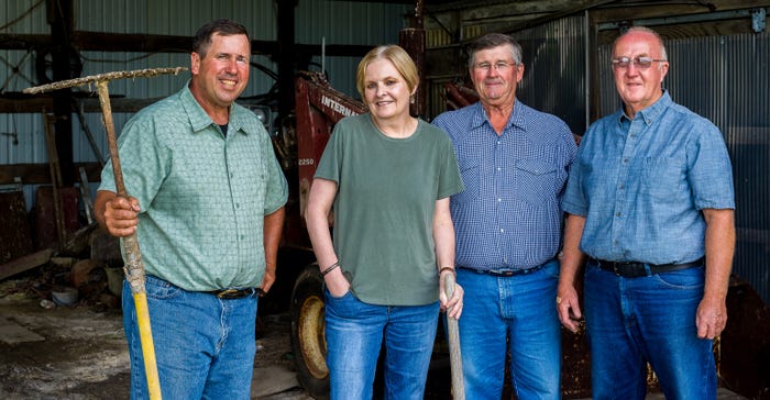 Mark O’Rourke, Cynthia Ryan, Bob Kuntz, and Fritz Robinson standing in  barn