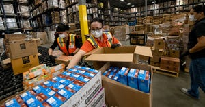 Workers at McLane Global pack meals for its Emergency Meals-To-You program