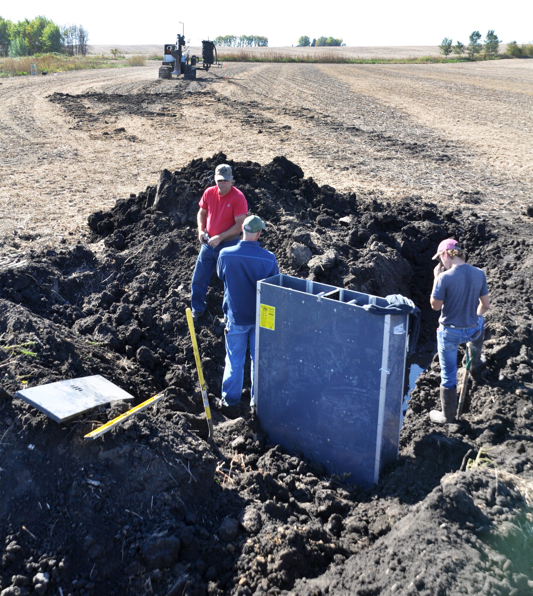 Men installing water control structure