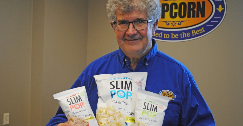Norm Krug, CEO of Preferred Popcorn at Chapman, Neb., holds just a few products from their full line of popcorn