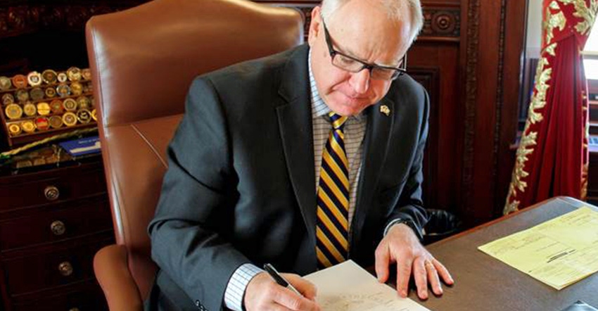 Minnesota Gov. Tim Walz signs a bill 
