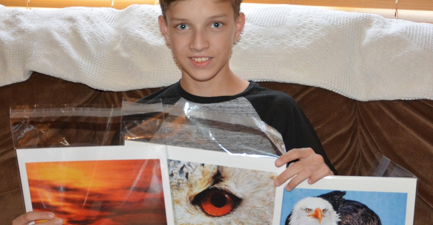: David Knoblauch, 13, is deciding which of his many photos he’ll enter in this year’s Kansas State Fair. He’s shown he