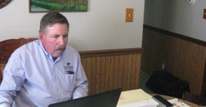 Duane Hund, director of the Farm Analyst program, checks through data from a Farm Analyst Program client