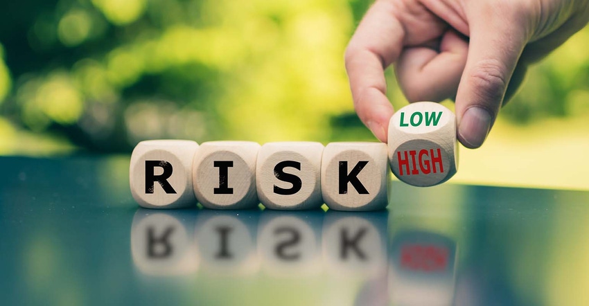 Cubes form the word "RISK" while a hand turns a cube and changes the word "high" to low"