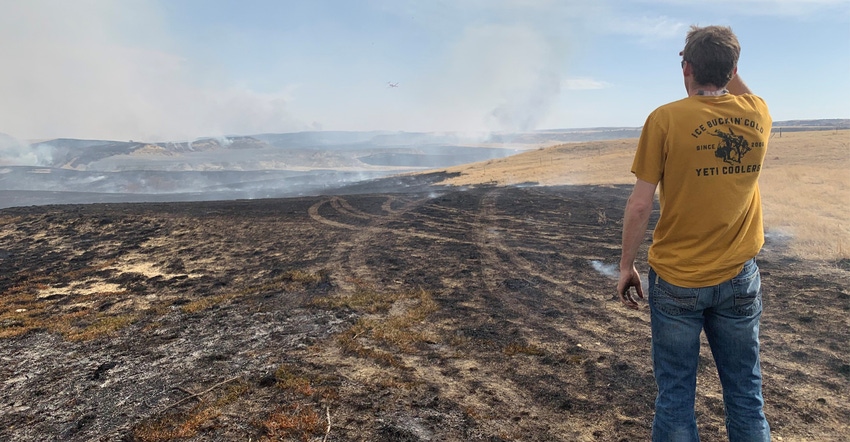 Ryan Monsen looks out over a grassland fire near his family farm in McKenzie County, North Dakota. Ryan Monsen looks out over a grassland fire near his family farm in McKenzie County, North Dakota.