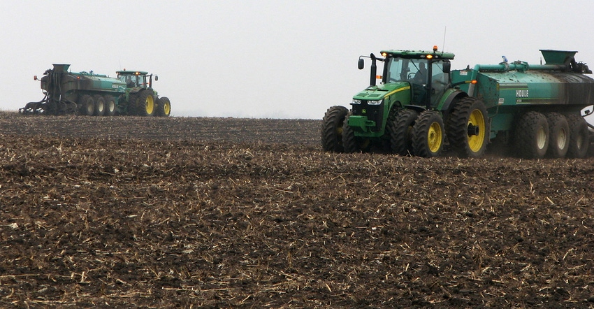 Tractors applying nutrients to soil