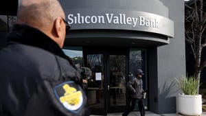 Security officer in front of Silicon Valley Bank sign
