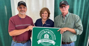 Dale Shumaker, Holly Spangler and Mike Ulen with Ulen Farms sign
