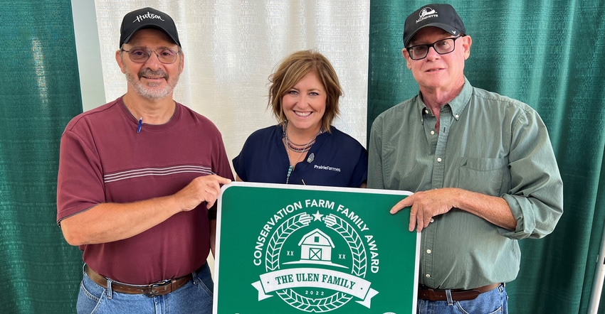 Dale Shumaker, Holly Spangler and Mike Ulen with Ulen Farms sign