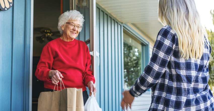 Groceries being delivered to older woman Groceries being delivered to older woman