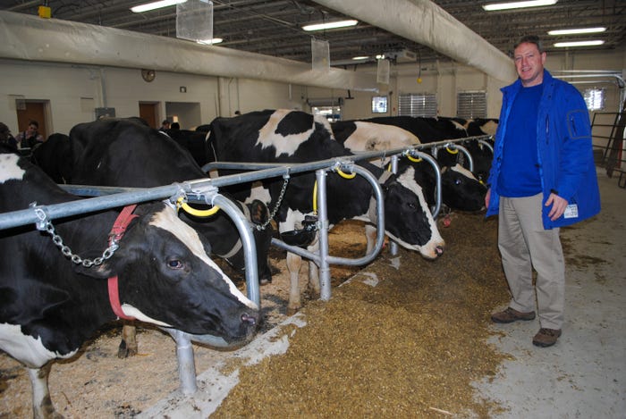 Kent Weigel, chair of the Department of Dairy Science at UW-Madison, posing in front of dairy cows