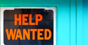 Help wanted sign taped to a window