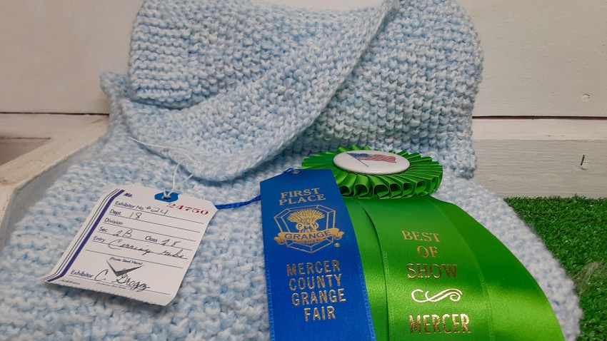 A  baby blanket wears the Best of Show ribbon for Carol Ann Gregg at the Mercer County Grange Fair