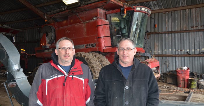 Ty and Jay Stukenholtz stand in front of one of their prototype FarmMax Interceptor
