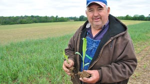 Dave Brandt holding soil and crop samples