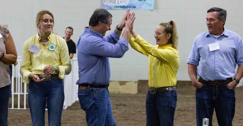 Agriculture Commissioner Doug Goehring high-fives his 14-year-old showmanship partner Paige Zimprich Agriculture Commissioner Doug Goehring high-fives his 14-year-old showmanship partner Paige Zimprich