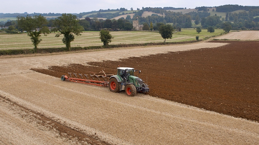 Tractor ploughing a field on a farm