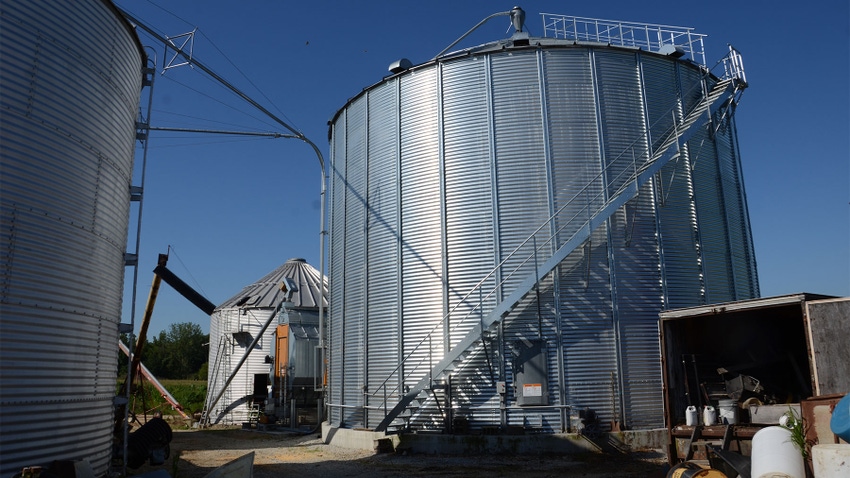 Large grain bins and dryer on a farm