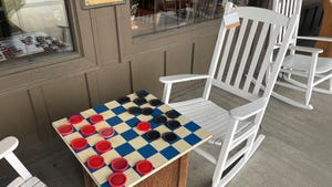 white rocking chair and checkerboard outside of Cracker Barrel restaurant