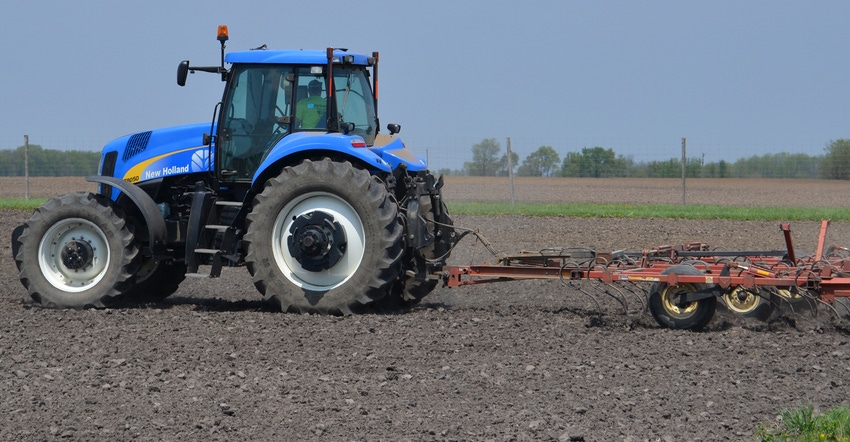tractor performing tillage in field tractor performing tillage in field