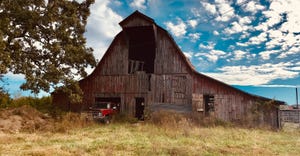 old barn against blue cloudy sky