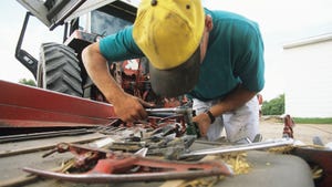 Man repairing farm equipment