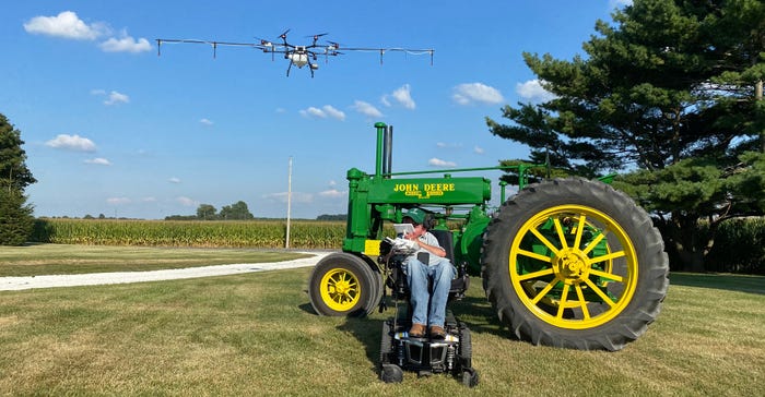Kyle Albertson flying a drone to spray and seed cover crops Kyle Albertson flying a drone to spray and seed cover crops