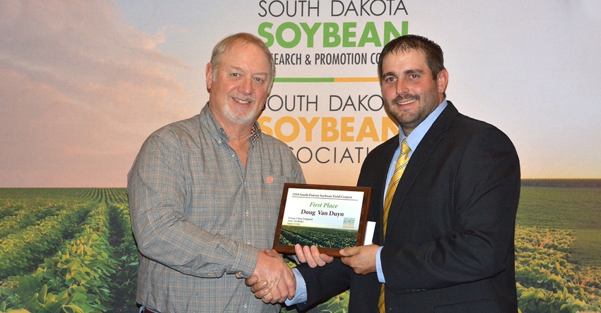 Doug Van Duyn (left) receives overall first place plaque in S.D. Soybean Yield Contest from Jon Schaeffer Doug Van Duyn (left) receives overall first place plaque in S.D. Soybean Yield Contest from Jon Schaeffer