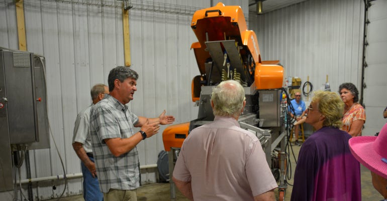 Robert Butz shows customers a Pellenc wine grape sorter he purchased from France
