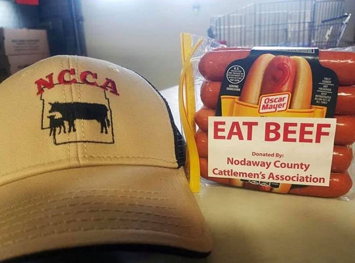 A package of beef hotdogs and a baseball cap with the Nodaway County Cattleman's Association logo