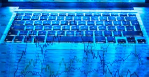 market chart on laptop keyboard