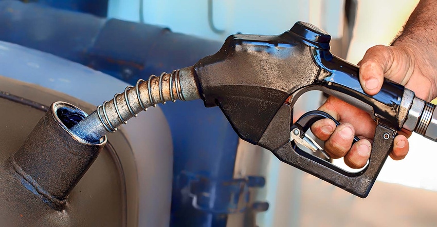 Person filling transport truck with fuel