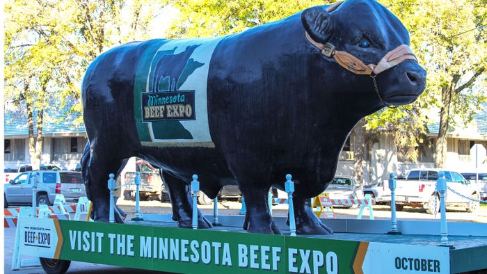 Large statue of bull with Minnesota Beef Expo sign on side