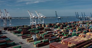 cargo containers are readied for transport at the port