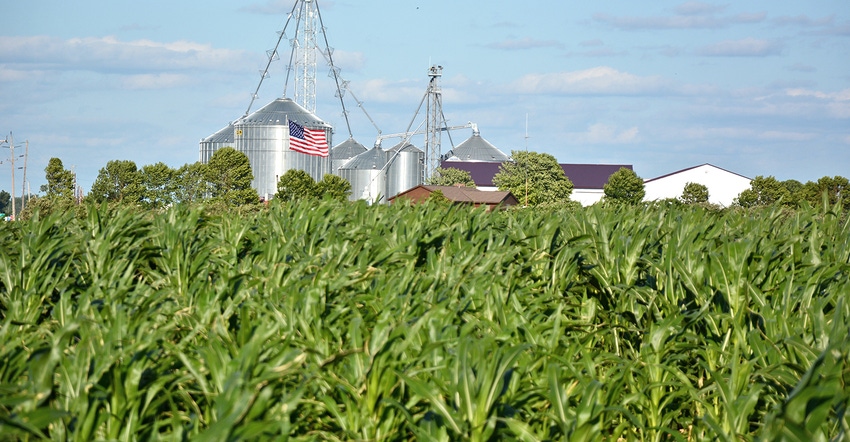 grain bins, corn field and U.S. flag