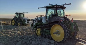 Two John Deere tractors with autonomous kits installed