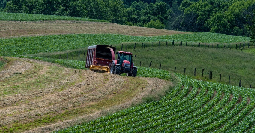 A hay tractor in a large field