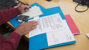 A close up of someone preparing tax paperwork