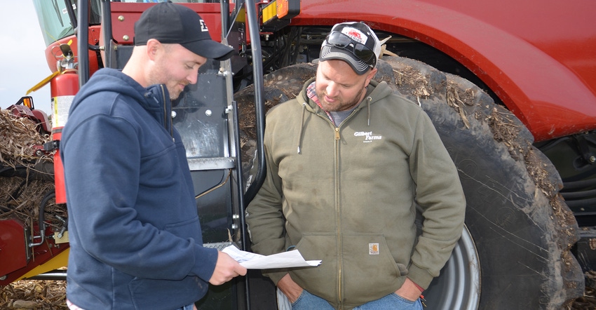 Dan Quinn and Josh Synesael checking paperwork