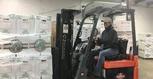 Wisconsin Food Hub Cooperative General Manager Tara Roberts-Turner moves food in the WFHC warehouse in Waupaca
