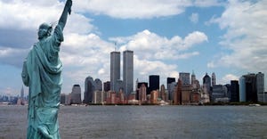 twin towers with statue of liberty in foreground