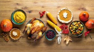 An overhead view of Thanksgiving foods on a wooden table