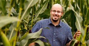 James Schnable stands between rows of corn in the field