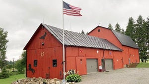  A red barn with an American flag on a flagpole